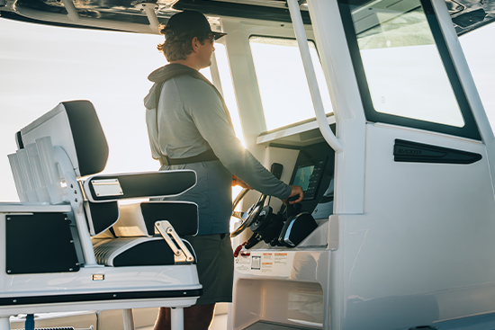 boat captain at helm on water