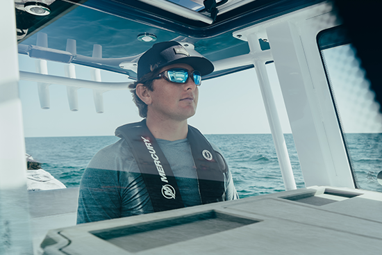 boat captain at helm on water