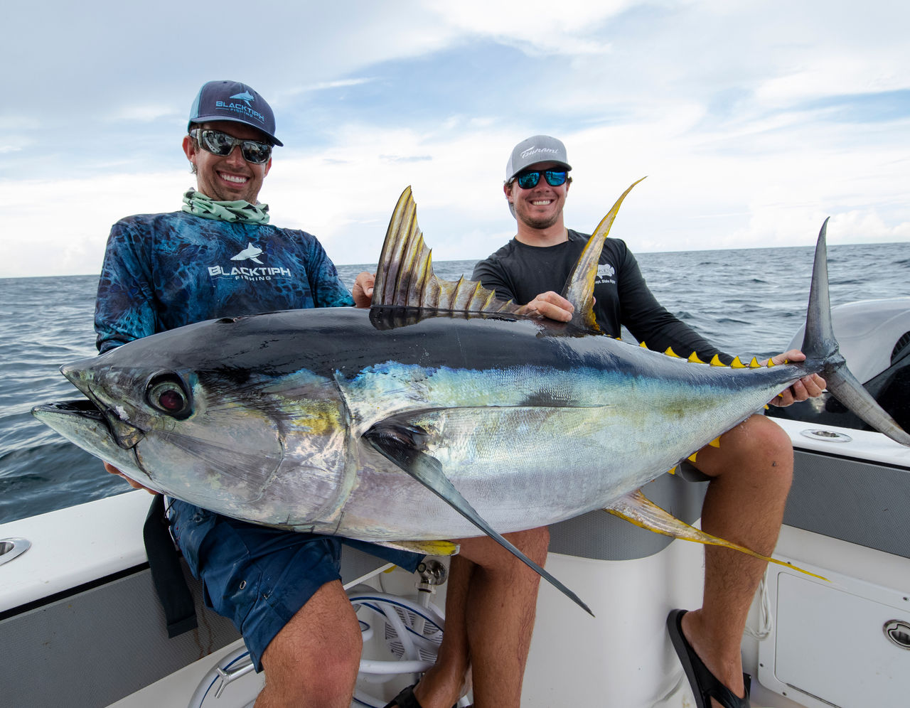 blacktiph holding fish on boat